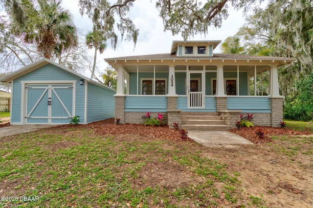 view of front of house with a porch and an outdoor structure