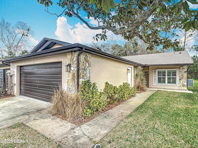 single story home with a garage and a front lawn