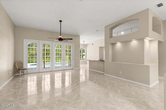 3 Slow Stream Way, Ormond Beach, FL 32174 - unfurnished living room with light tile patterned flooring, ceiling fan, track lighting, and french doors