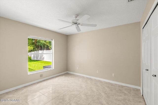 3 Slow Stream Way, Ormond Beach, FL 32174 - unfurnished bedroom with a closet, a textured ceiling, light tile patterned floors, and ceiling fan