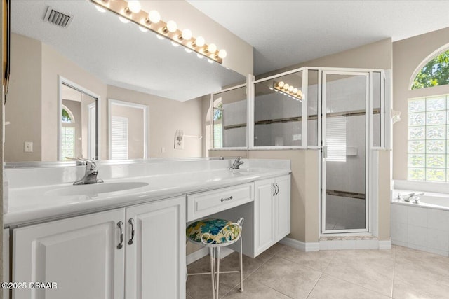 3 Slow Stream Way, Ormond Beach, FL 32174 - bathroom featuring double vanity, a stall shower, a bath, tile patterned flooring, and a textured ceiling