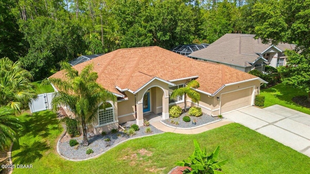 3 Slow Stream Way, Ormond Beach, FL 32174 - mediterranean / spanish home featuring an attached garage, stucco siding, driveway, roof with shingles, and a gate