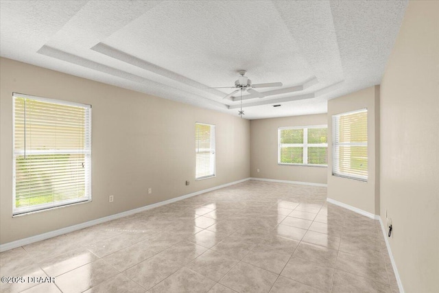 3 Slow Stream Way, Ormond Beach, FL 32174 - unfurnished room featuring a raised ceiling, a textured ceiling, a ceiling fan, and light tile patterned floors