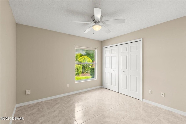 3 Slow Stream Way, Ormond Beach, FL 32174 - unfurnished bedroom featuring a closet, a textured ceiling, light tile patterned floors, and ceiling fan