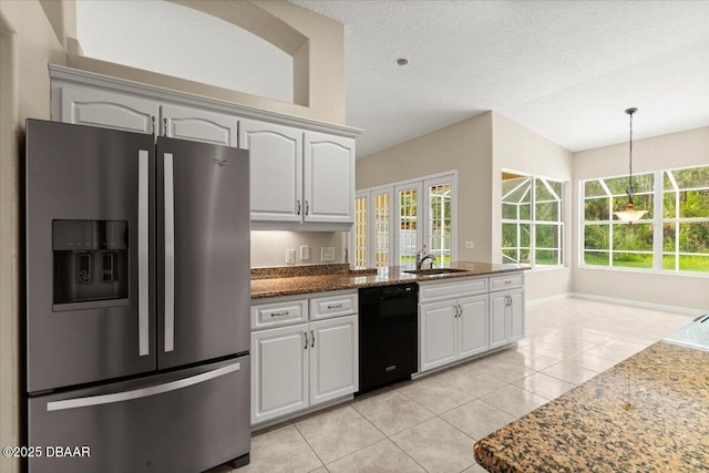 3 Slow Stream Way, Ormond Beach, FL 32174 - kitchen with stainless steel fridge with ice dispenser, dishwasher, light tile patterned floors, dark stone counters, and decorative light fixtures