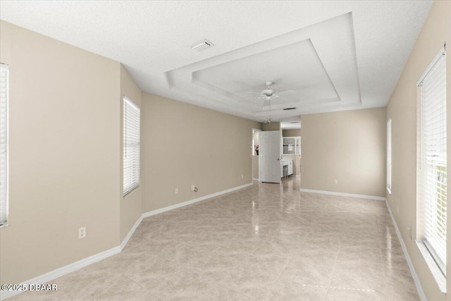 3 Slow Stream Way, Ormond Beach, FL 32174 - empty room featuring ceiling fan, a raised ceiling, and light tile patterned floors