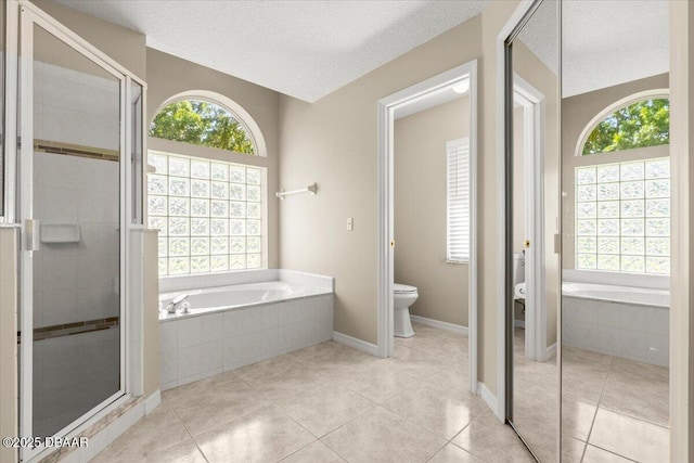 3 Slow Stream Way, Ormond Beach, FL 32174 - bathroom with healthy amount of natural light, a bath, tile patterned flooring, a textured ceiling, and a shower stall