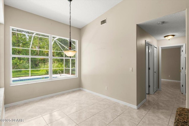 3 Slow Stream Way, Ormond Beach, FL 32174 - unfurnished dining area with healthy amount of natural light, light tile patterned flooring, and a textured ceiling