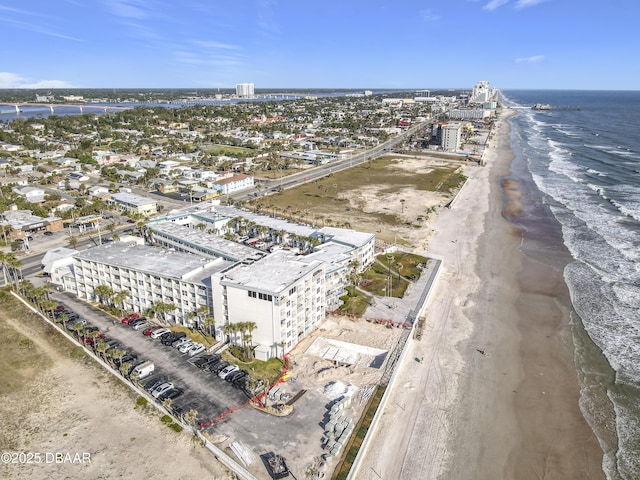 aerial view with a water view and a view of the beach