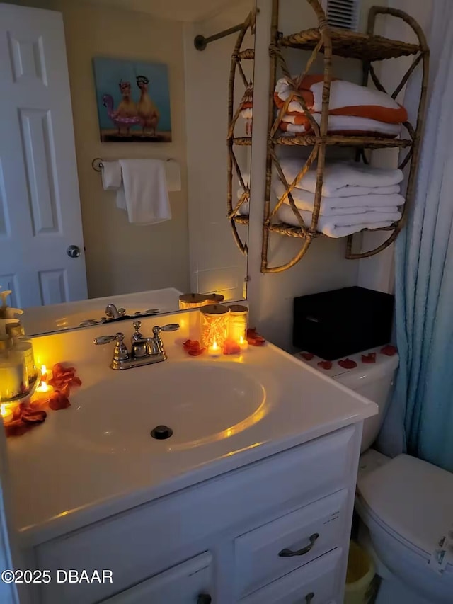 bathroom featuring toilet and vanity