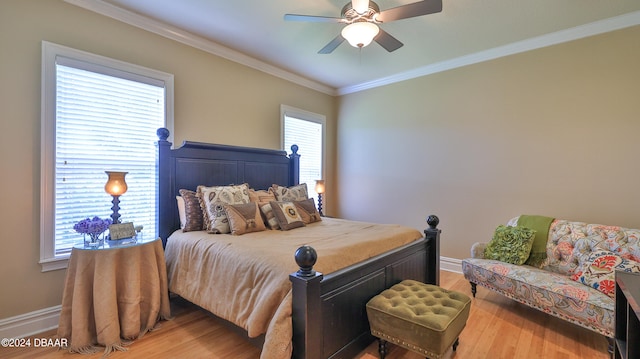 bedroom featuring hardwood / wood-style flooring, ceiling fan, and crown molding