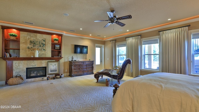 carpeted bedroom featuring ceiling fan, a fireplace, a textured ceiling, and ornamental molding