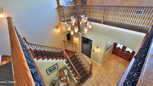 stairs featuring a chandelier