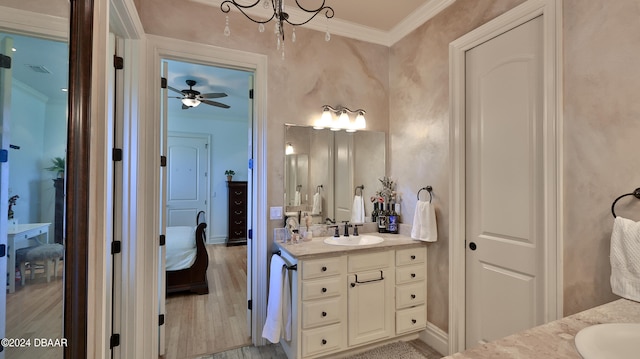 bathroom with hardwood / wood-style floors, vanity, ceiling fan, and ornamental molding