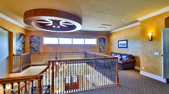 corridor featuring an inviting chandelier, carpet floors, a textured ceiling, and ornamental molding