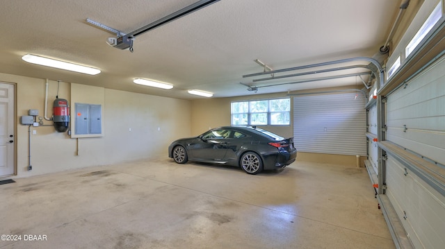 garage with electric panel and a garage door opener