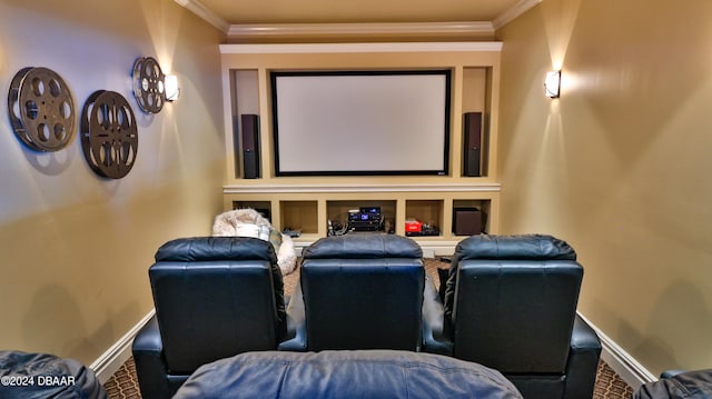 carpeted cinema room featuring crown molding