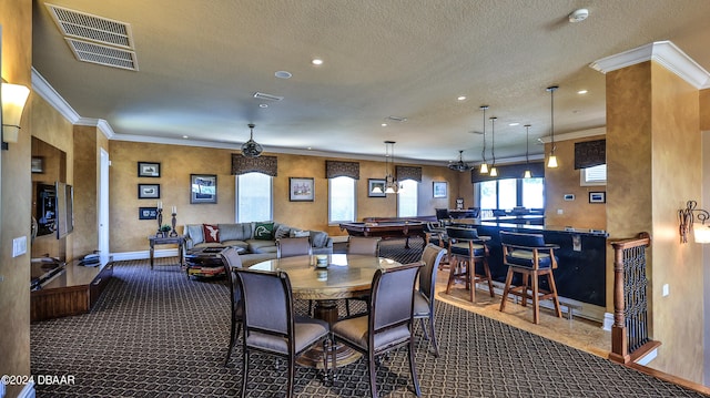 dining area featuring crown molding, dark colored carpet, a textured ceiling, and pool table