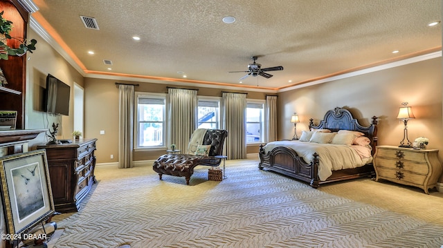 bedroom with a textured ceiling, light colored carpet, ceiling fan, and crown molding