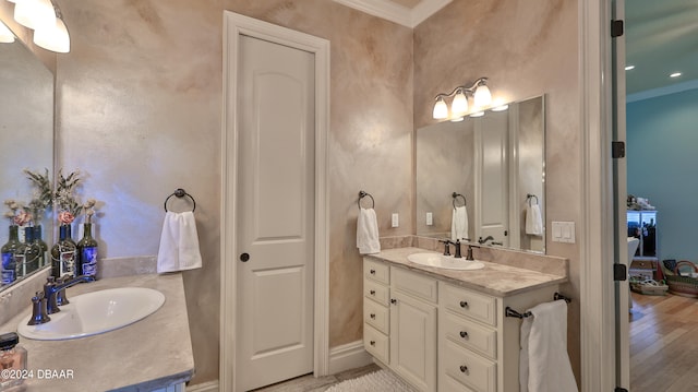 bathroom with wood-type flooring, vanity, and ornamental molding