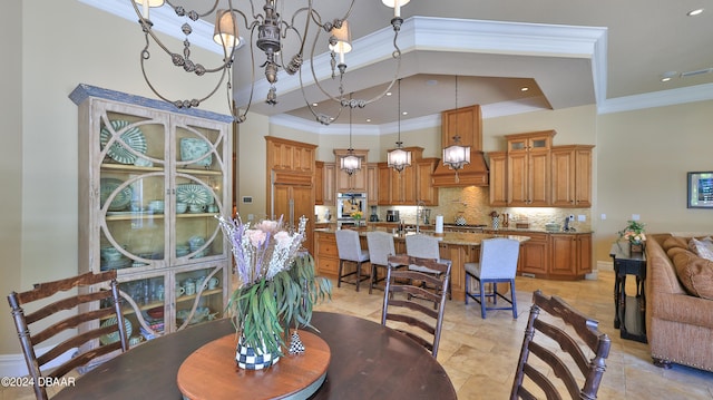 dining room featuring ornamental molding and an inviting chandelier