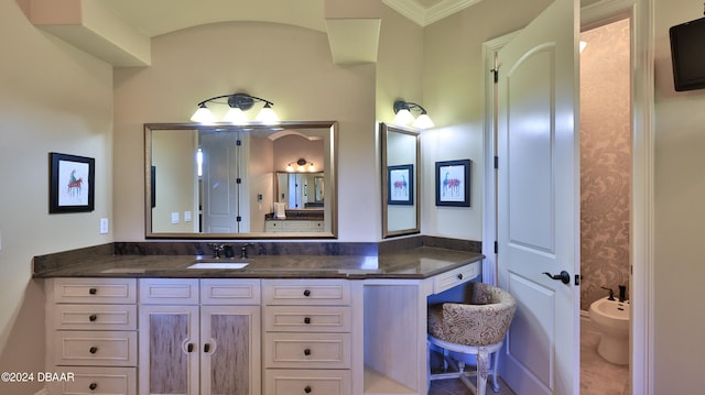 bathroom featuring vanity, crown molding, and a bidet