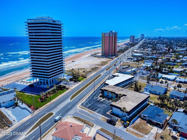 drone / aerial view featuring a water view and a view of the beach
