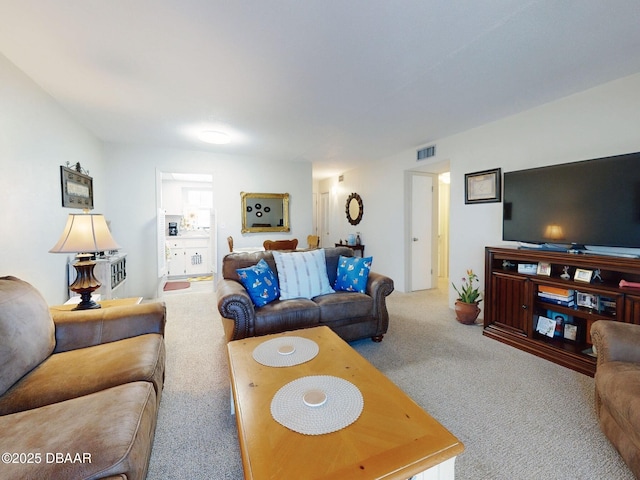 living area featuring carpet and visible vents