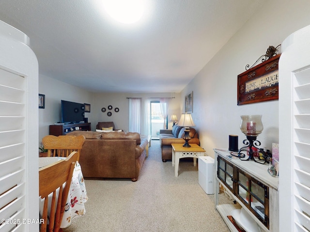 living area featuring light carpet