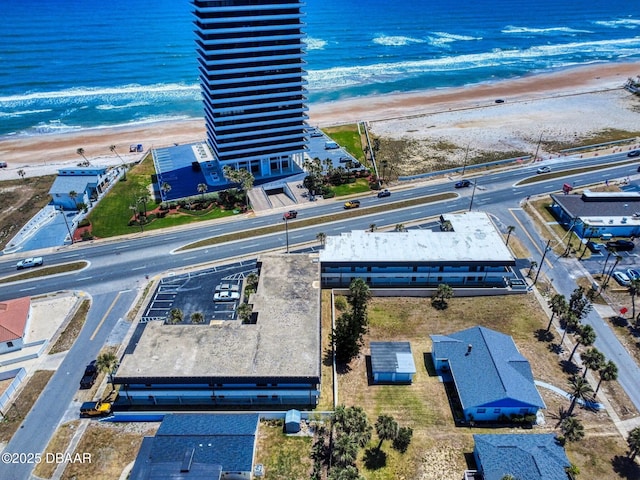 bird's eye view featuring a view of the beach and a water view