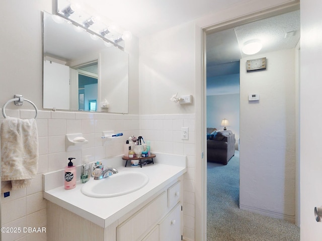 bathroom with vanity and tile walls