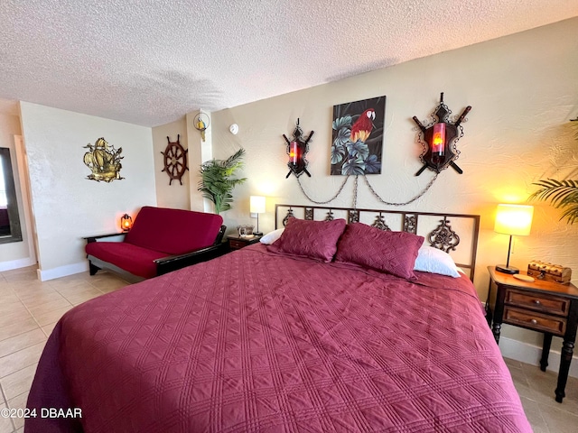 bedroom featuring light tile patterned flooring and a textured ceiling