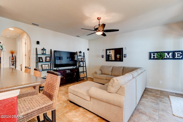 living room featuring light tile patterned floors and ceiling fan