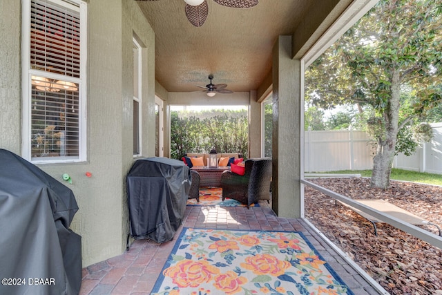 view of patio / terrace with area for grilling, ceiling fan, and an outdoor living space