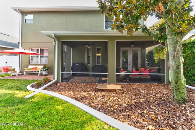 back of property featuring ceiling fan and a patio area