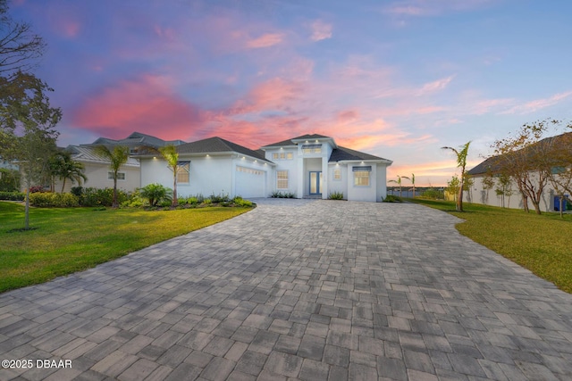 view of front facade featuring a garage and a yard