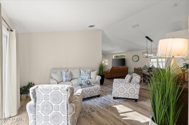1589 Town Park Dr, Port Orange, FL 32129 - living room featuring vaulted ceiling, a notable chandelier, and light hardwood / wood-style floors