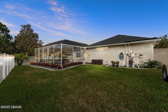 1589 Town Park Dr, Port Orange, FL 32129 - back house at dusk featuring a yard and a lanai