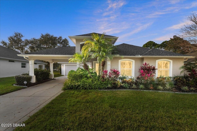 view of front of property with a garage and a yard