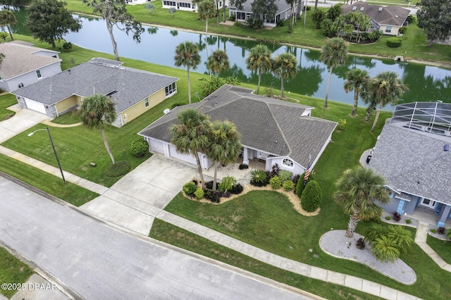 drone / aerial view featuring a residential view and a water view