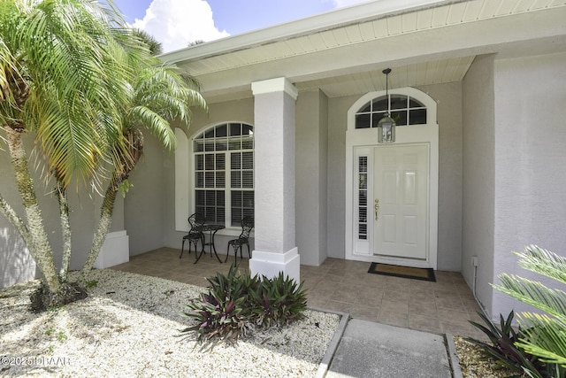 entrance to property with stucco siding and a porch