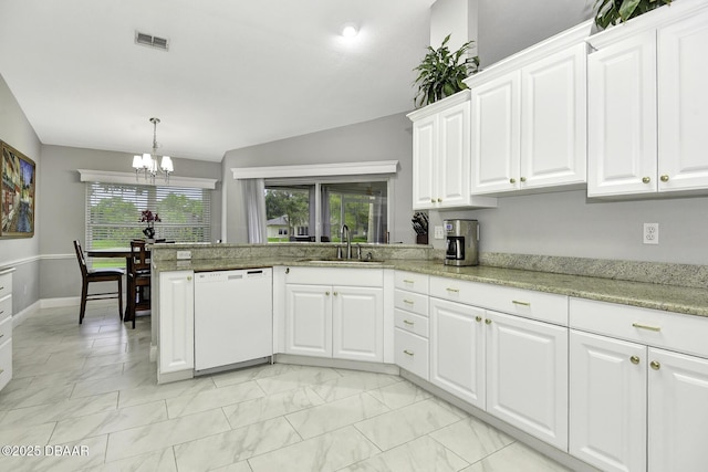 kitchen with visible vents, white dishwasher, a sink, vaulted ceiling, and a notable chandelier