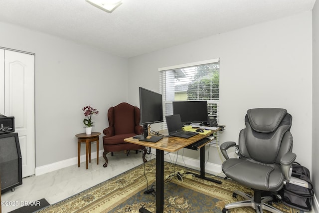 home office with baseboards and a textured ceiling