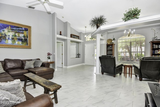 living area with visible vents, high vaulted ceiling, marble finish floor, ceiling fan with notable chandelier, and decorative columns