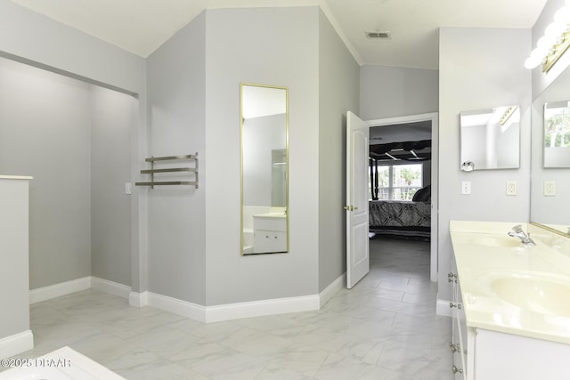 ensuite bathroom with a sink, connected bathroom, marble finish floor, and visible vents