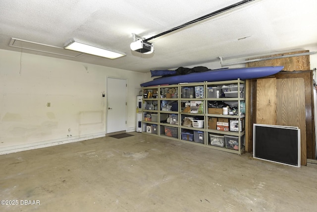 garage with electric water heater and a garage door opener