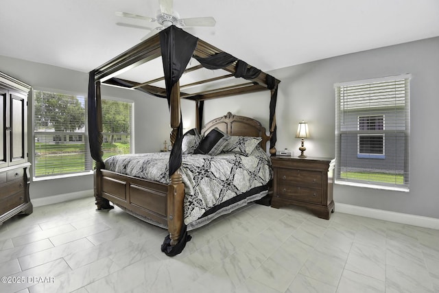 bedroom with baseboards, marble finish floor, and ceiling fan