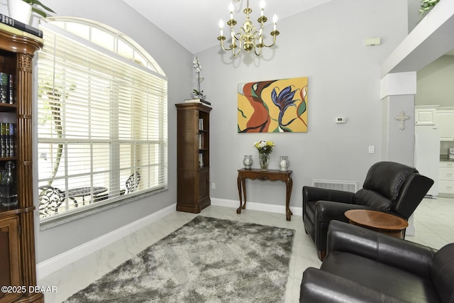 living area featuring baseboards, lofted ceiling, visible vents, and a chandelier