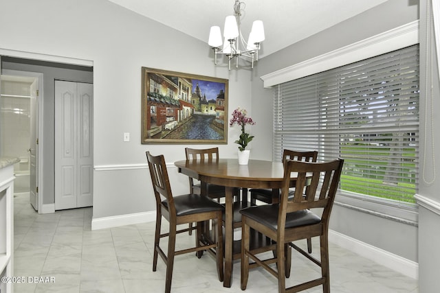 dining room with baseboards, marble finish floor, and a chandelier