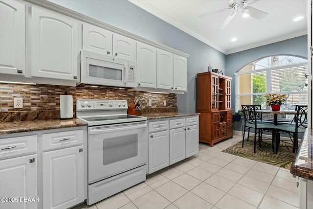 kitchen with white appliances, tasteful backsplash, white cabinetry, and ornamental molding